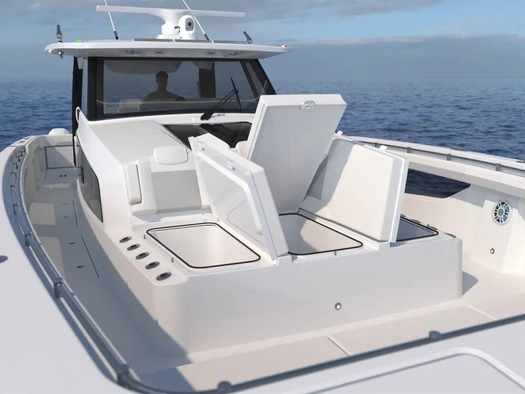 Modern boat interior with a helm and spacious deck; storage compartments are open, revealing their empty interiors.